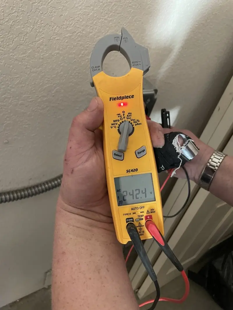 Voltage testing with clamp meter during Recessed Lighting Installation in Clemson
